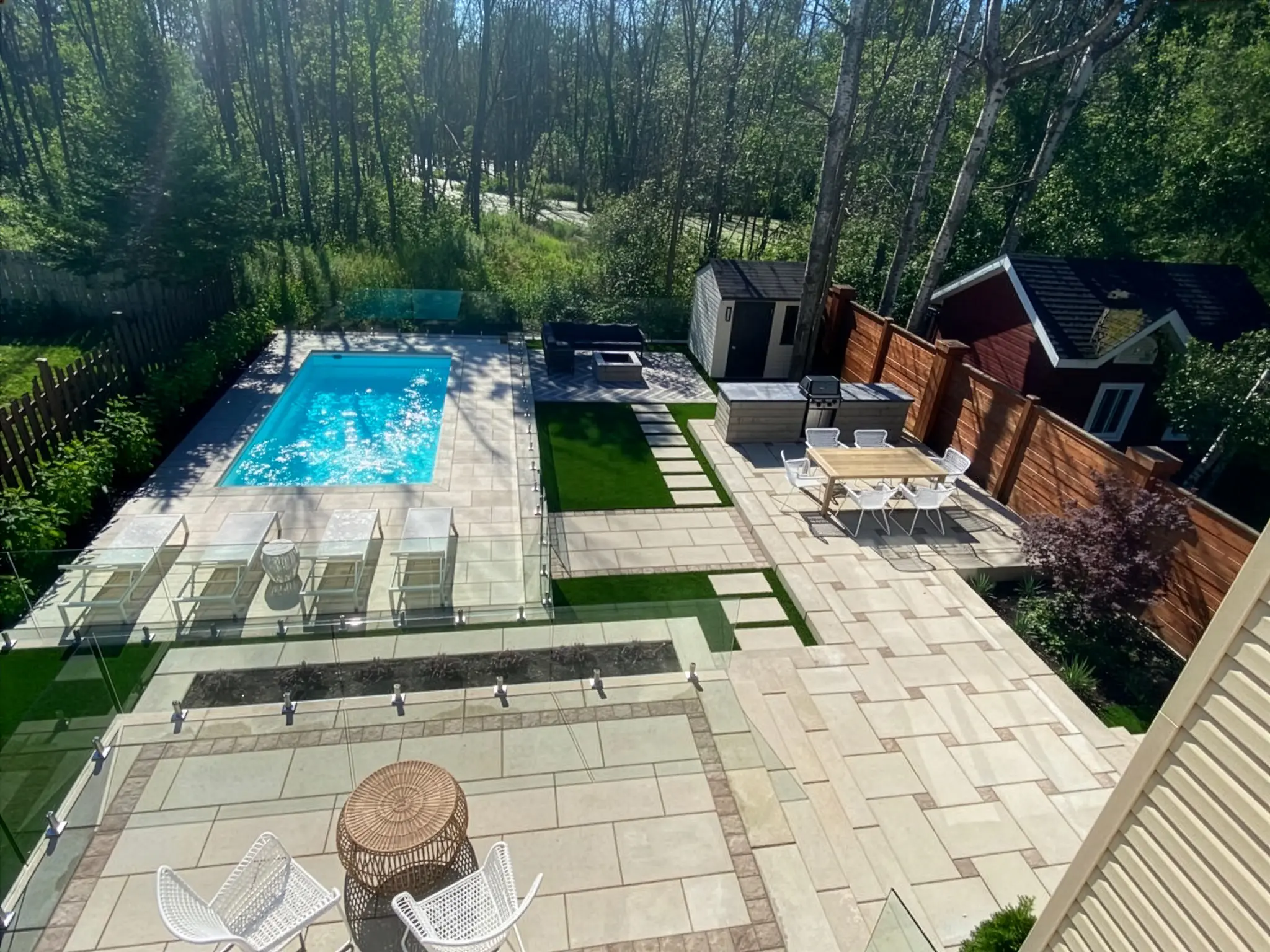 Patio en pavé uni autour d'une piscine avec gazon artificiel et espace repas extérieur, Longueuil